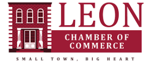 Logo for the Leon Chamber of Commerce featuring a red brick building and bold text. The slogan below reads, "Small Town, Big Heart.