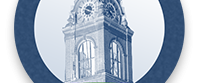 A circular emblem featuring a clock tower with "Est. 1850" above and a green banner below that reads "Decatur County.